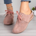 Women's black lace-up wedge slippers with a suede upper and rubber sole on a white background.