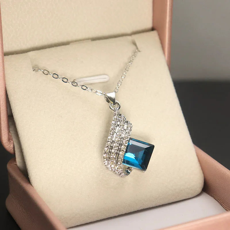 Alloy pendant necklace and matching earrings with glass ornamentation and cross chain design
