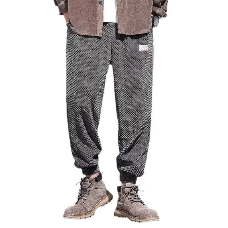 Men's grey straight leg sweatpants with ankle strap detail on a plain background.