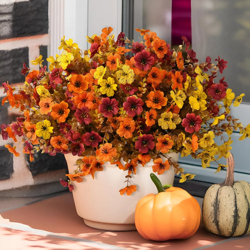 Artificial flower bouquet in autumn orange, yellow, and red colours with detailed plastic and silk construction