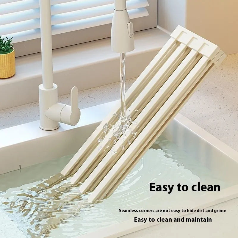 Foldable milky white stainless steel kitchen draining rack shown open and folded, next to a sink.
