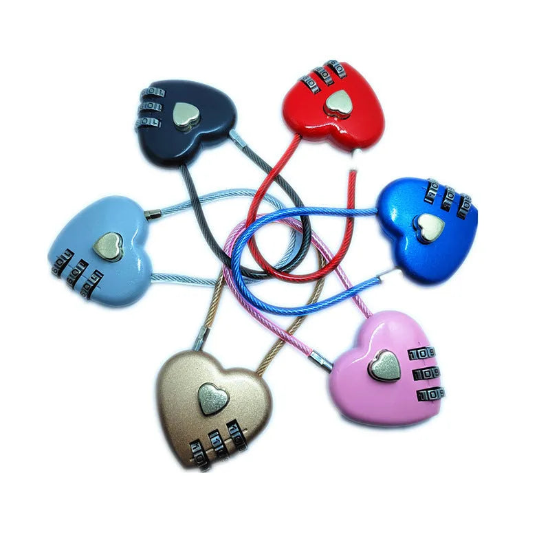 Peach heart shaped wire rope lock in multiple colours with a long steel cable, shown next to a bicycle helmet.