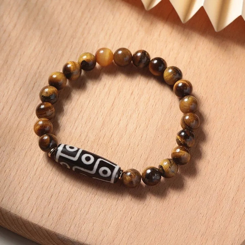Single tigereye bead ethnic Buddha bracelet on wrist, showing simple rosary style.