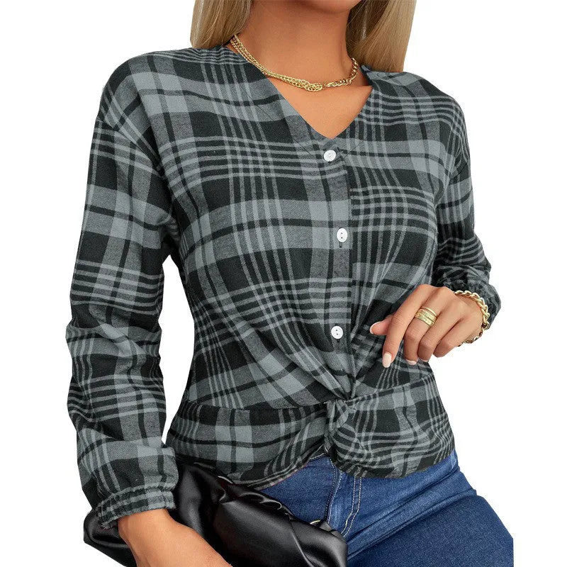 A woman wearing a loose-fitting purple plaid shirt with regular sleeves.