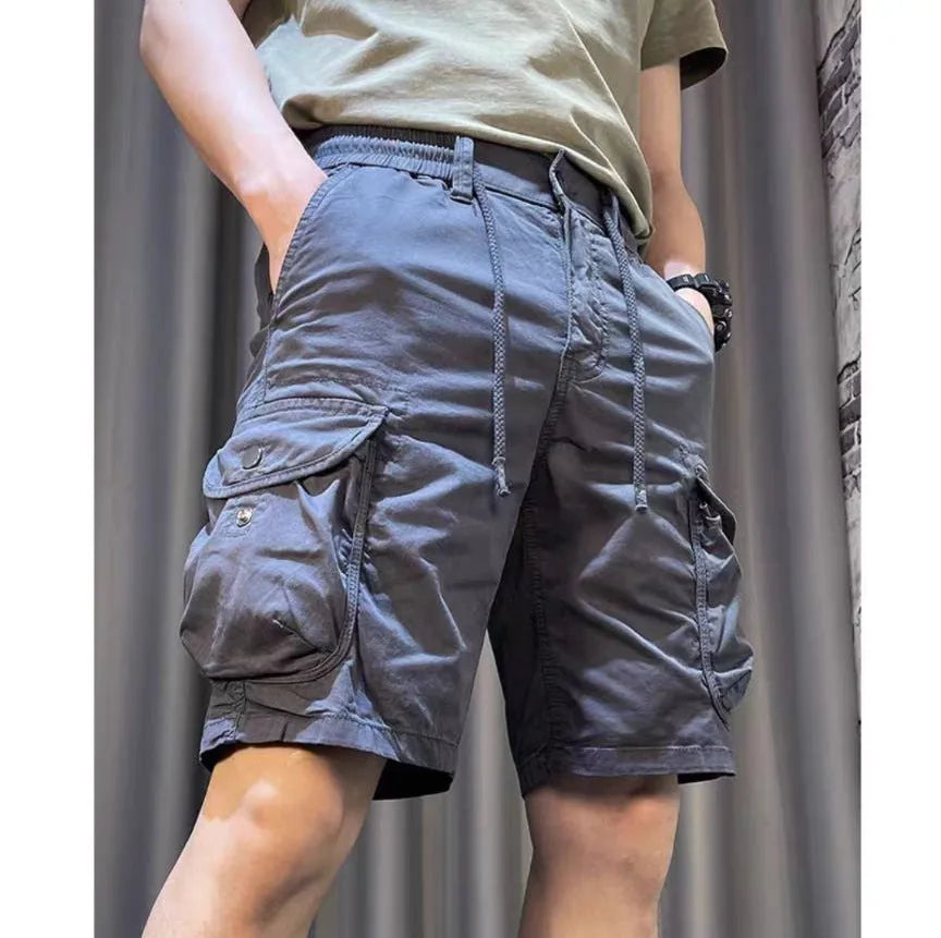 Loose straight-leg overalls pants in khaki with multiple cargo pockets on the legs.