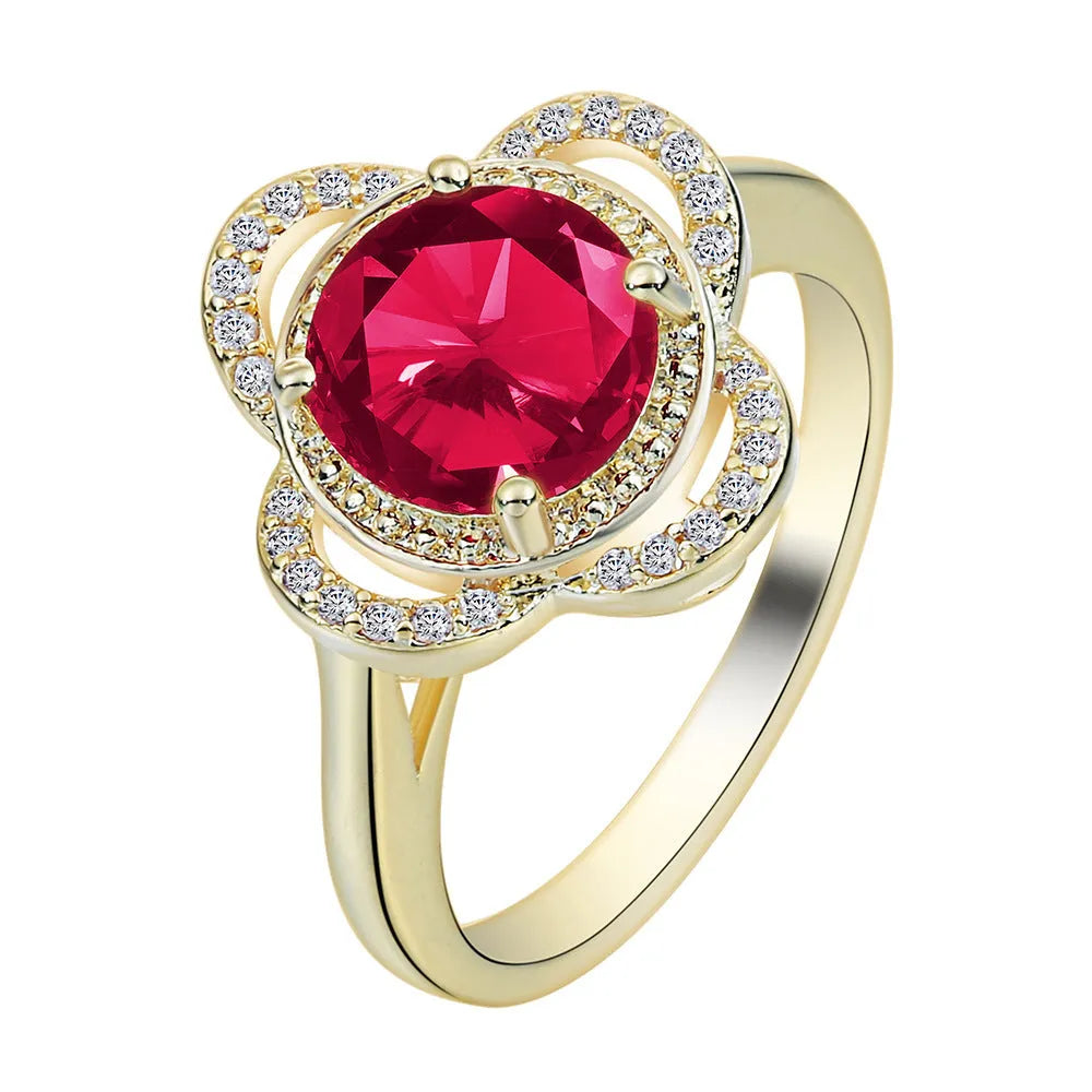 Copper ring with a fruit shape design and zircon stone inlays on a hand.