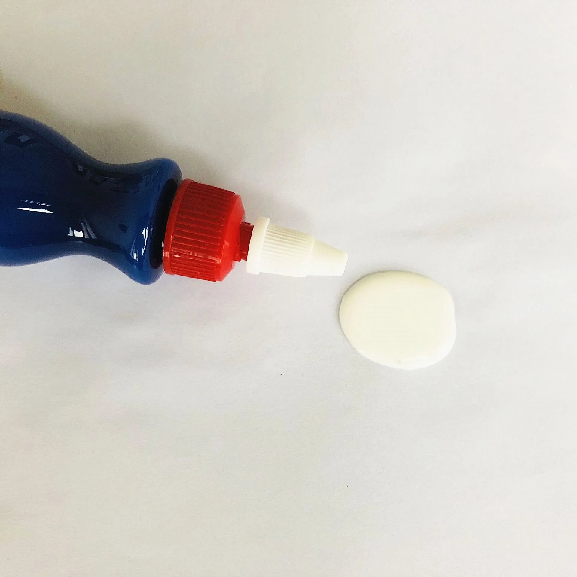 Small blue car scratch repair agent bottle with application tool for automobile bodywork