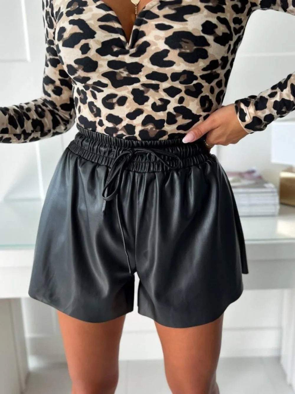 Women's black wide-leg casual shorts with lace-up waist detail and PU leather accents