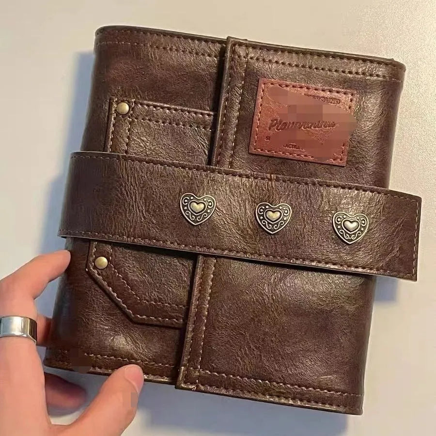 Brown A7 size notebook with a PU leather-look cover and metal buckle closure.