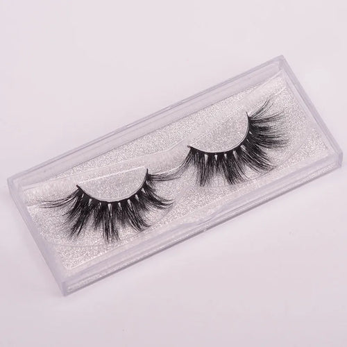 Handmade 5D mink false eyelashes set with brush and storage cap on a white background.