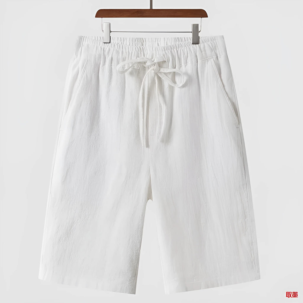 Men's beige linen loose cropped casual shorts on a neutral background.