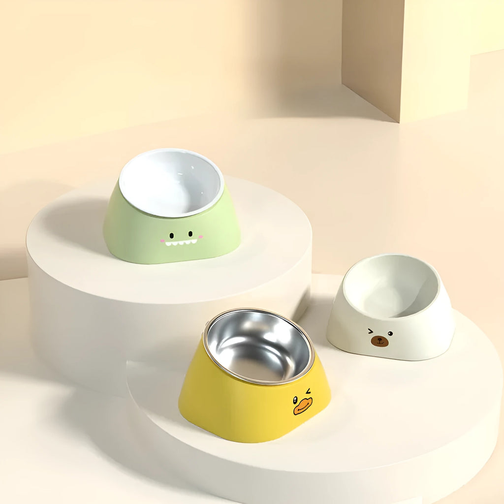 Green tilted stainless steel cat bowl on a white surface.
