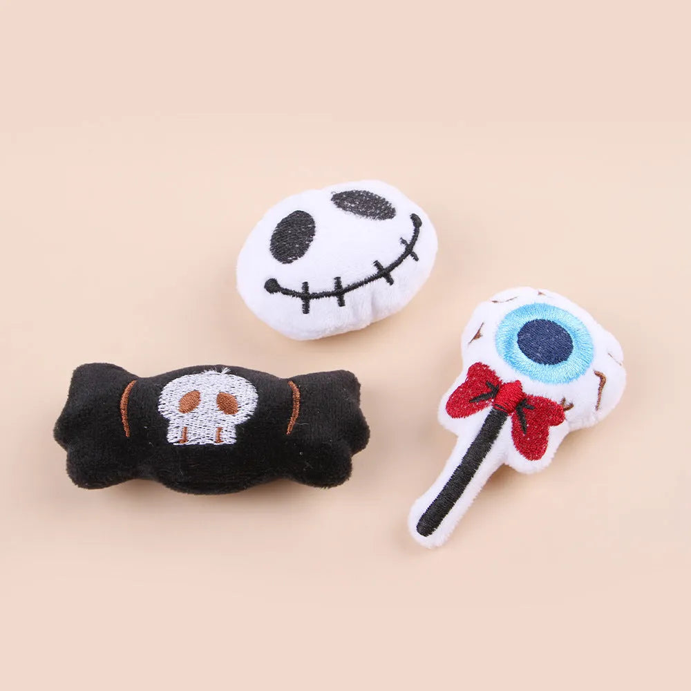 Plush cat teaser toy with candy, eyes and skull attachments on handheld wand