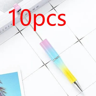 Colourful spinning plastic beaded ballpoint pen showing rotating barrel design.