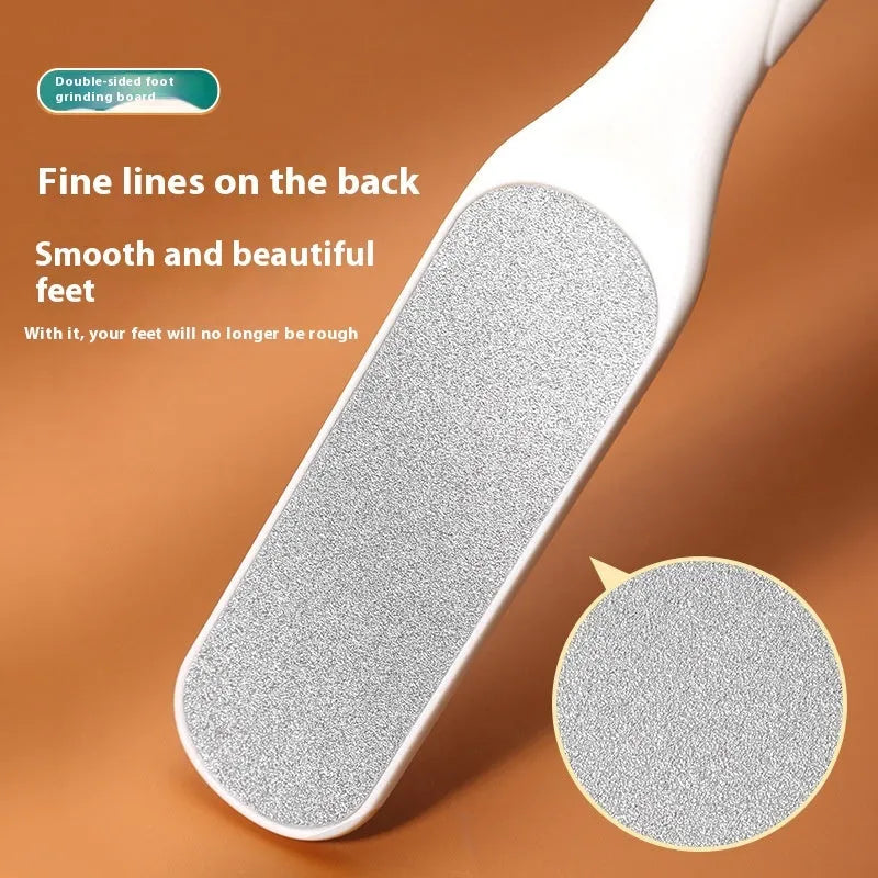 Stainless steel foot grinder with white and black double-sided abrasive attachments for foot care
