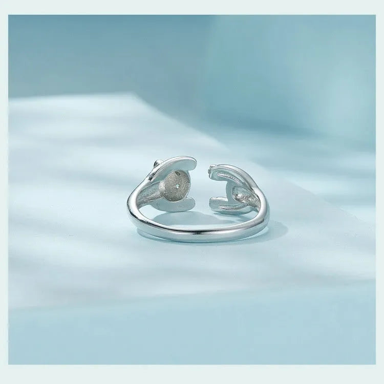 Adjustable sterling silver panda ring with white gold plating on a finger