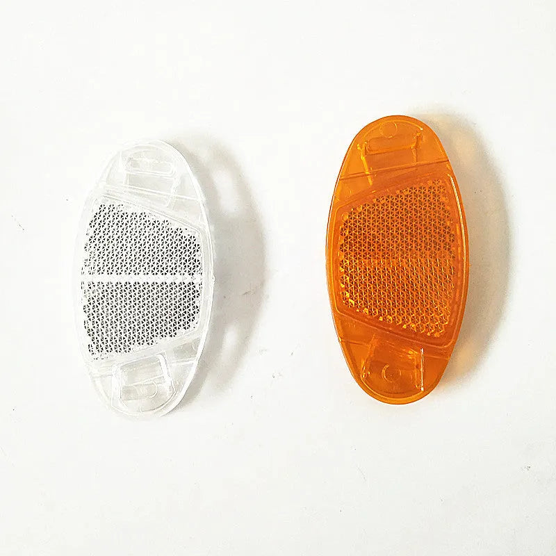 White and yellow plastic bicycle reflector spoke decorations measuring 7.2cm by 3.5cm