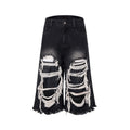 Black cropped wide-leg women's jeans with ripped patches on the knees.