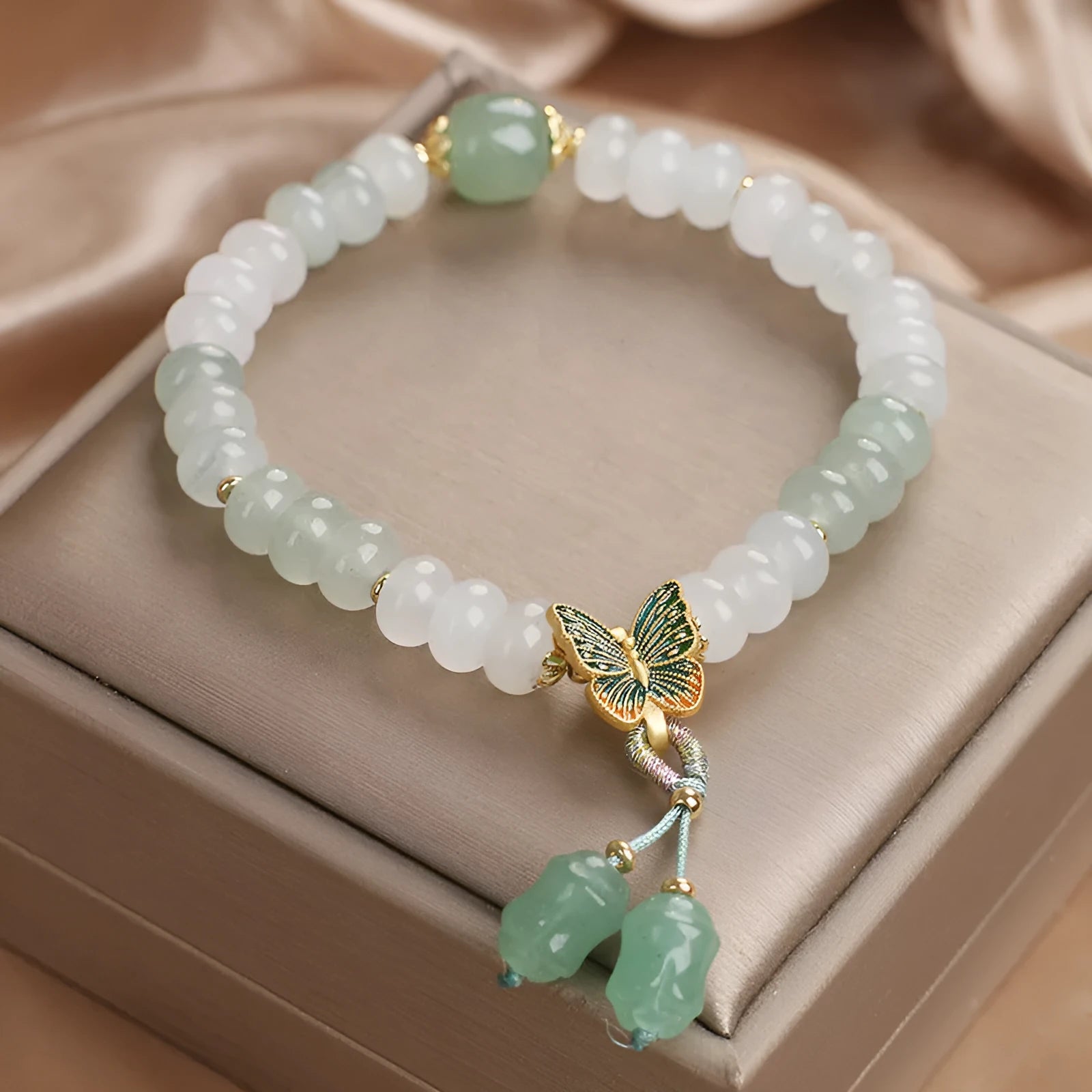 Green crystal women's bracelet with abacus beads and butterfly tassel decoration