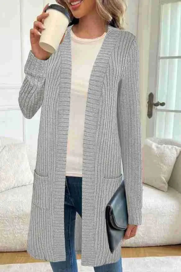 Loose fit grey knitted cardigan jacket with long sleeves and patch pockets on a hanger.