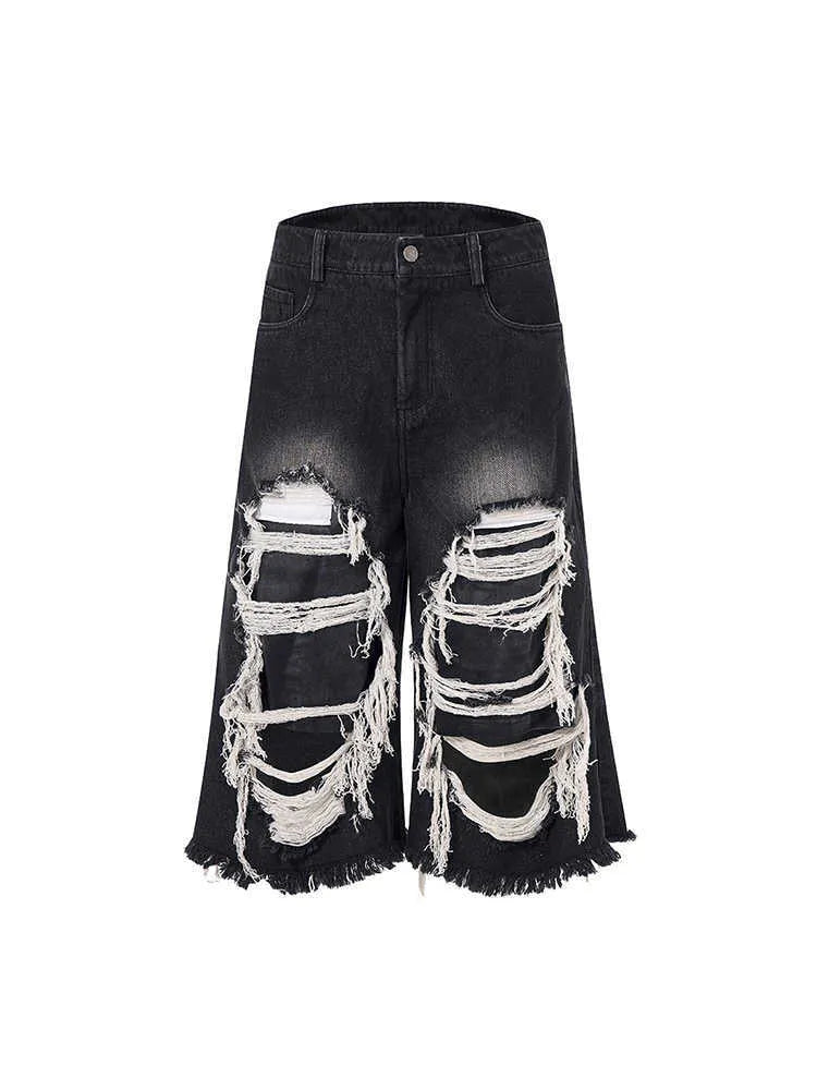 Black cropped wide-leg women's jeans with ripped patches on the knees.