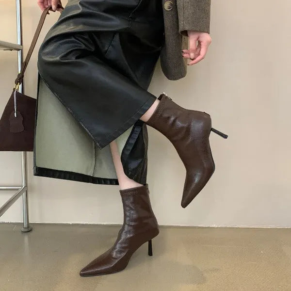 Stiletto heel ankle boots in black faux leather with pointed toe, tassel detail and back zipper, sizes 35-40