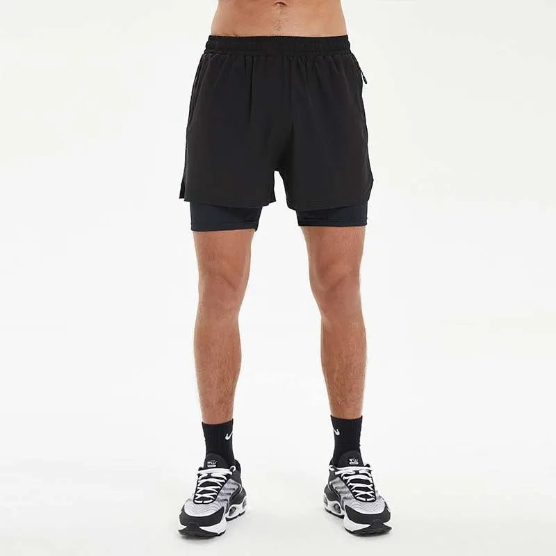 Man wearing black double-layer sports shorts with a spandex liner for running, showing short length and mid waist design.