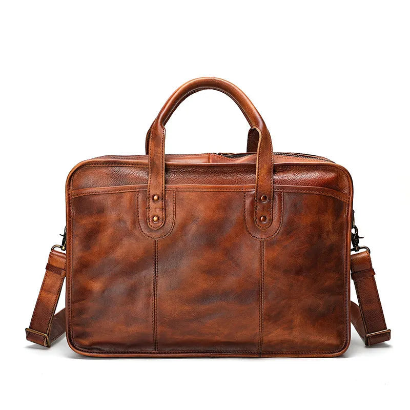 Large vintage leather men's briefcase showing internal laptop, document, camera, and phone compartments