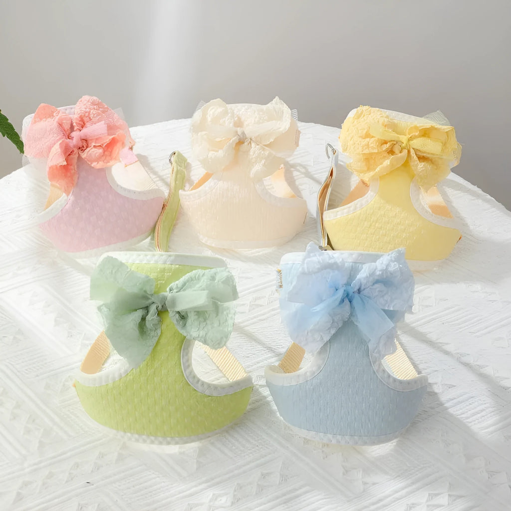 Small puppy hand-held rope chest strap in beige cloth on a wooden floor