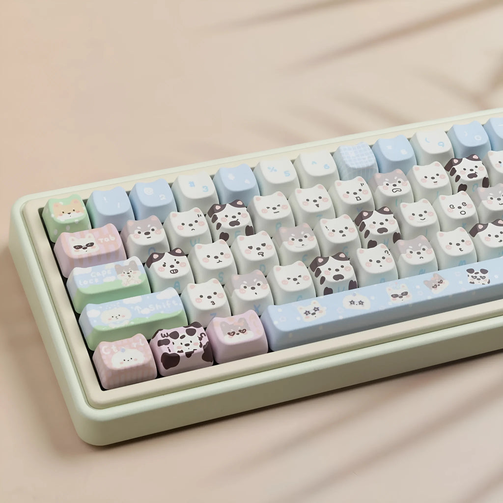 PBT sublimation keycap set showing cat and puppy character designs on mechanical keyboard keys