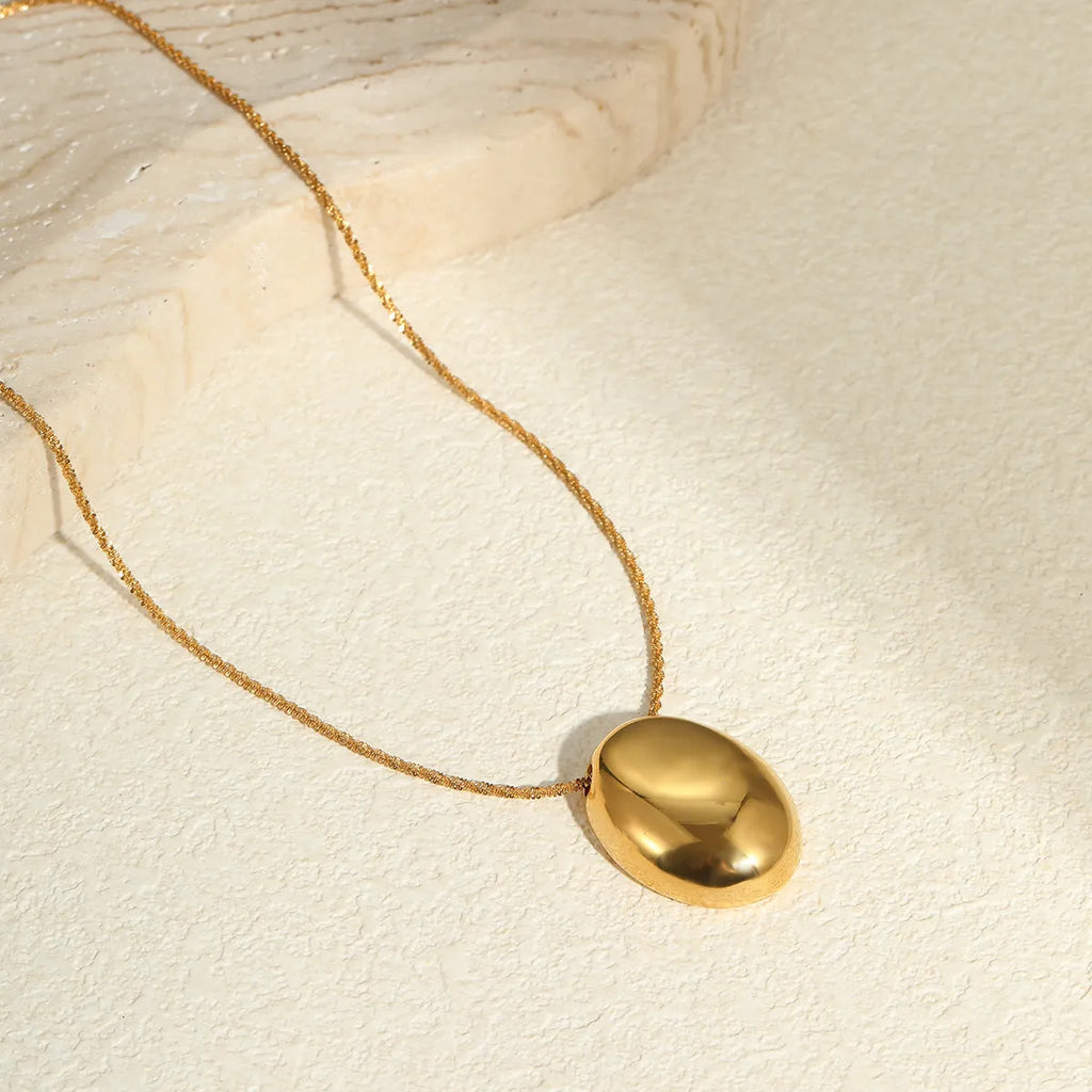 Gold geometric pendant necklace on adjustable stainless steel chain, shown at 41cm length.