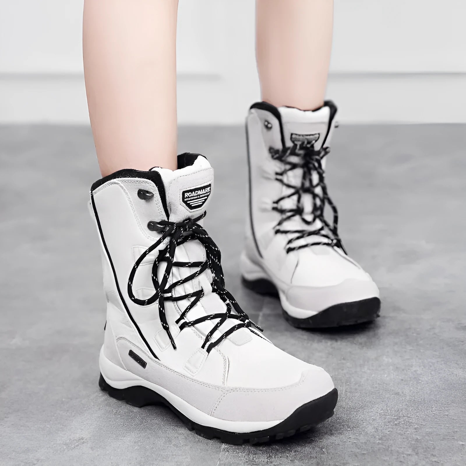 Women's mid-calf thermal snow boots in black with a genuine leather upper and rubber sole.