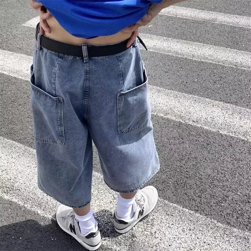 Blue men's cropped high-waisted denim-style shorts with a zipper fly on a white background.