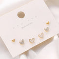 Three pairs of heart-shaped women's earrings in gold, black, and pink colour options
