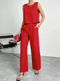 Red women's two-piece set featuring a sleeveless round-neck top and matching wide-leg trousers on a hanger.