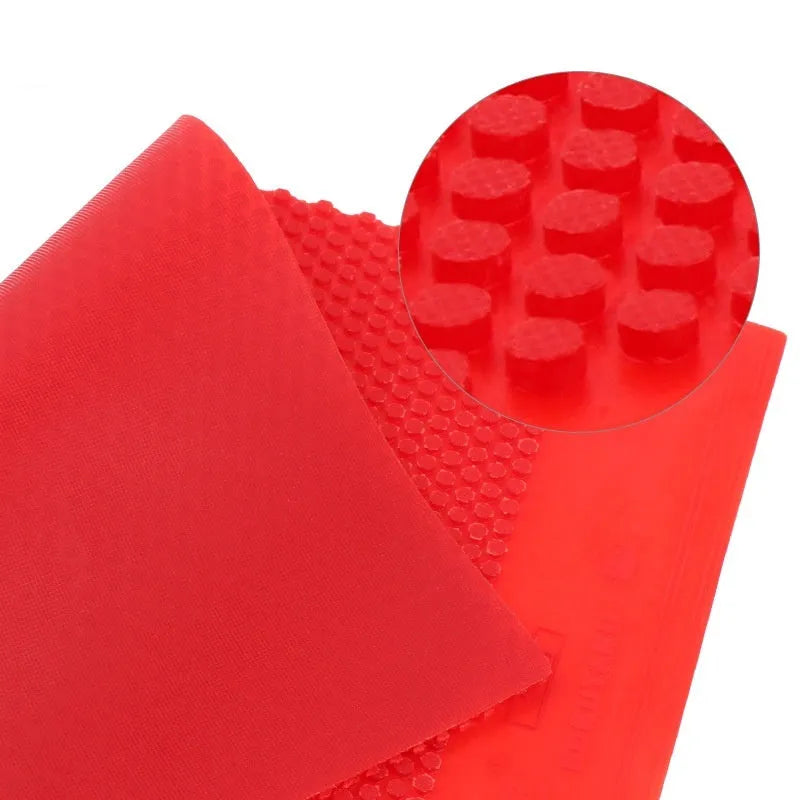 Single sheet of black table tennis rubber with small particle texture.