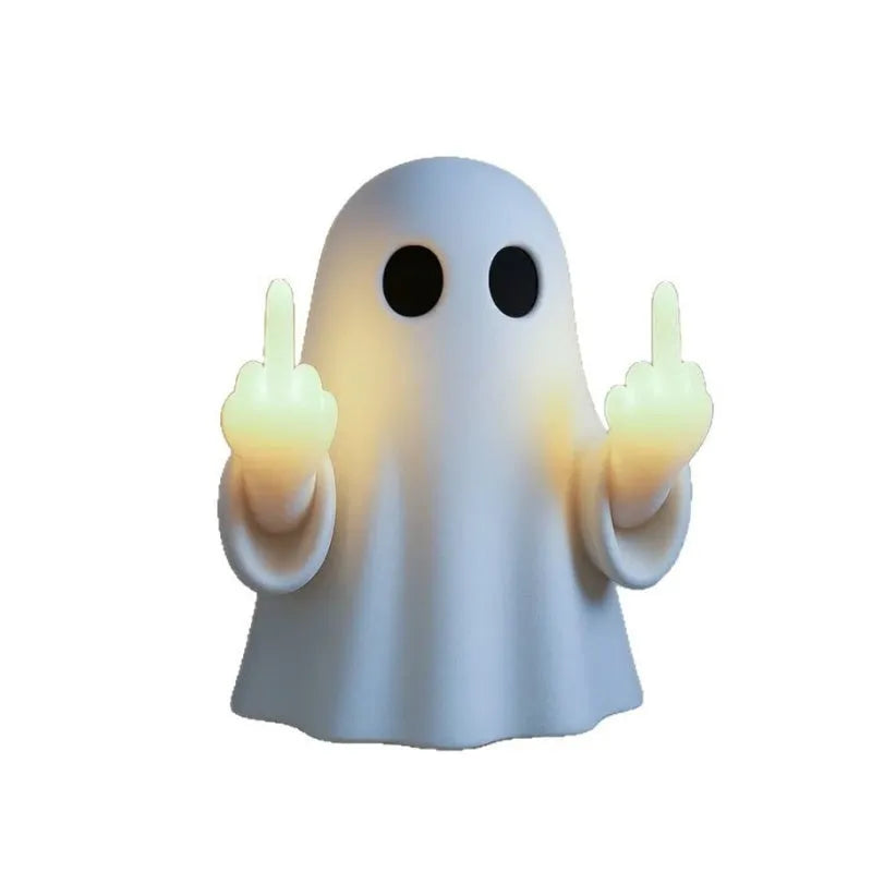 Small white ghost statue night lamp on a shelf for Halloween decor.