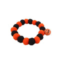 Orange pumpkin print cat collar with plastic buckle and small metal bell attached.