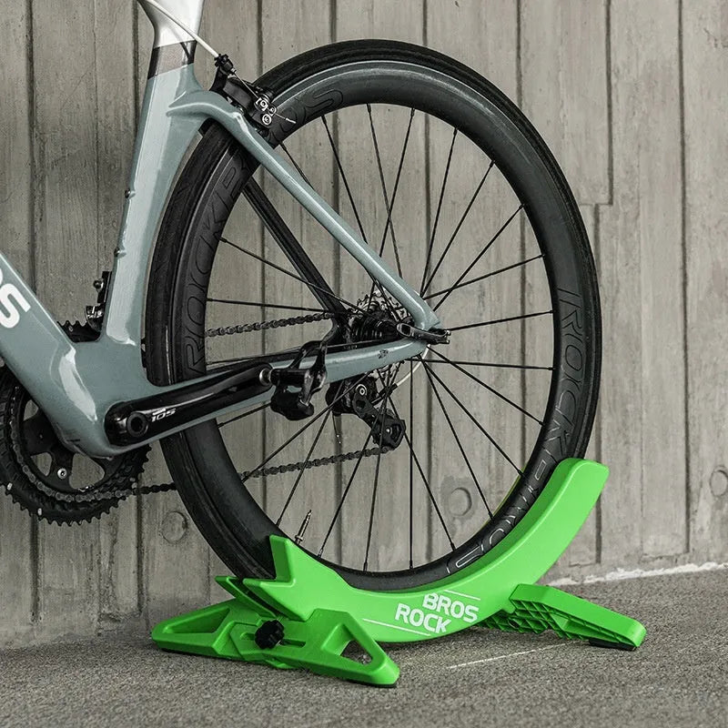 Black and green ABS plastic fixed bracket for mountain bike and road bike parking.