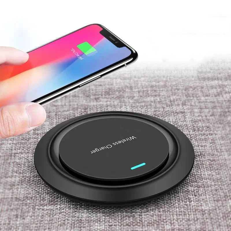 Round white desktop wireless charger with USB cable showing 10W fast charging for mobile phones