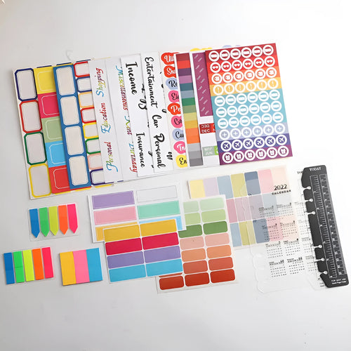 Assortment of paper adhesive stickers, labels, A6 rulers, and sticky notes in various colours and grid layouts.