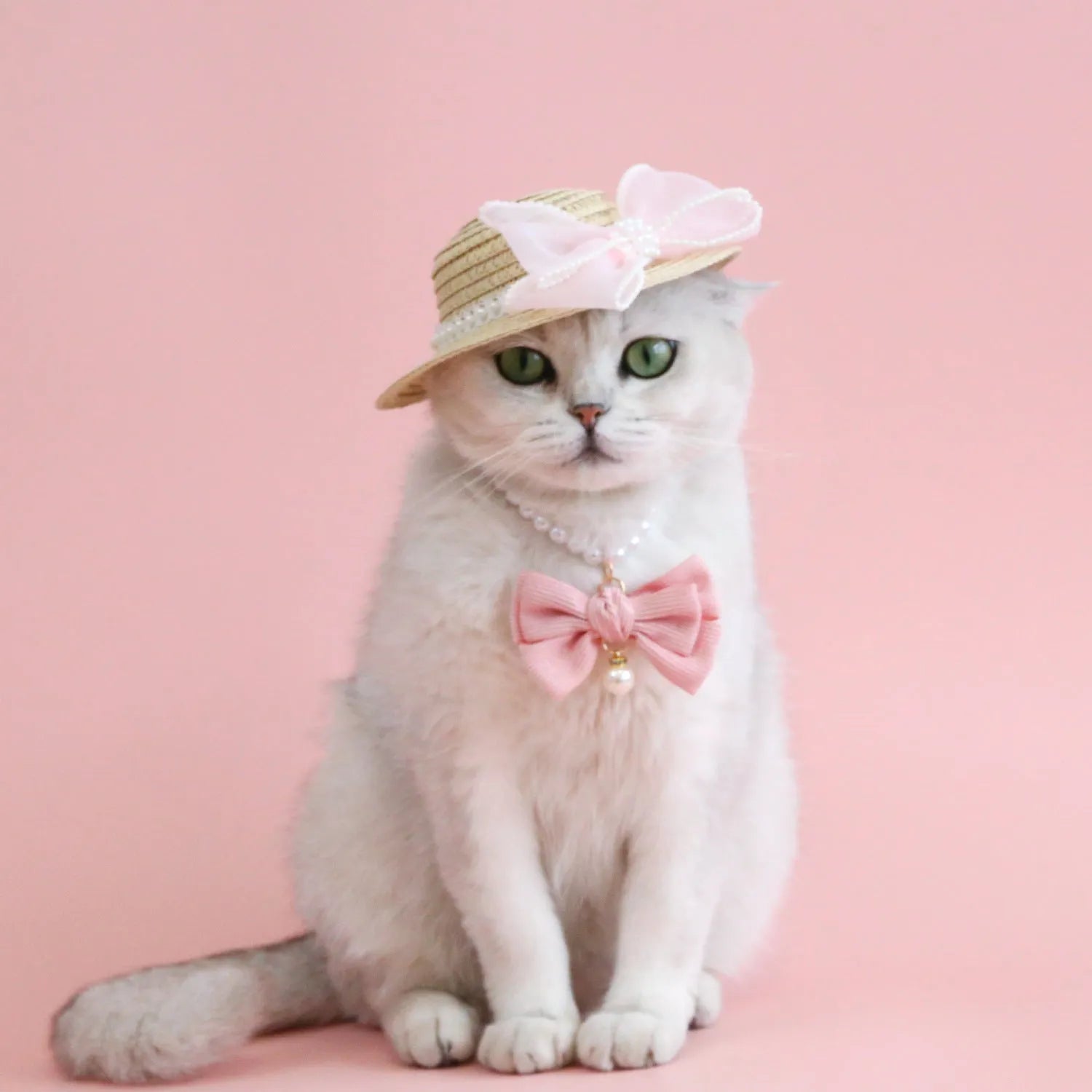 Woven straw pet hat with pearl bow decoration in pink, purple, blue or white colour options