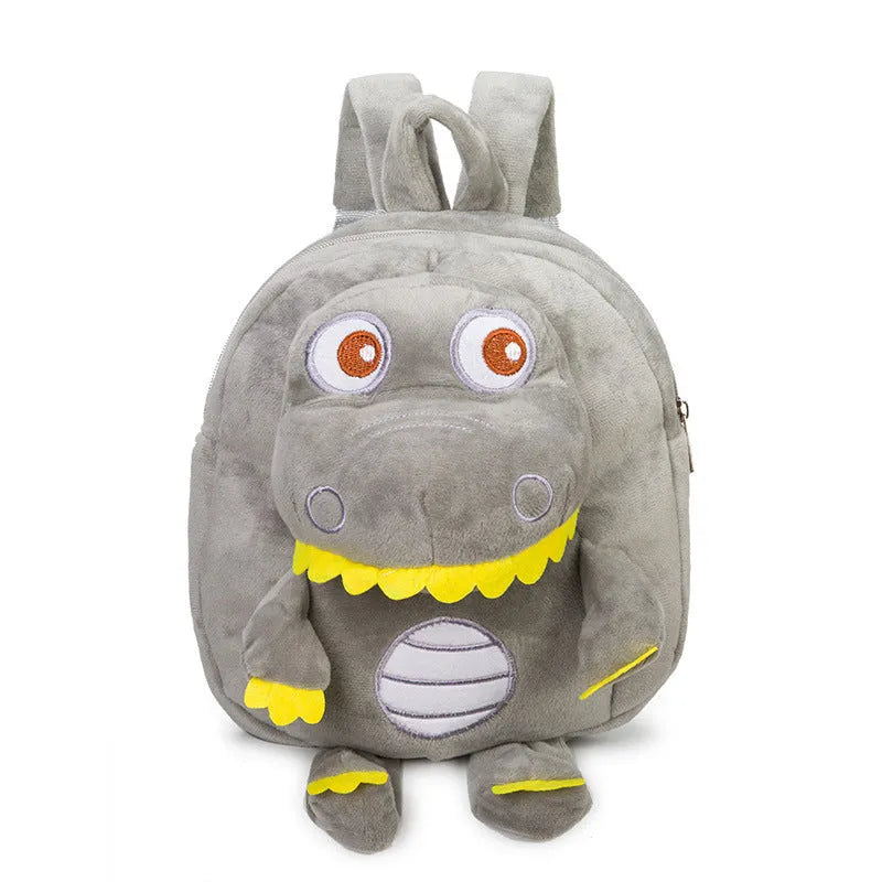 Blue dinosaur plush backpack with embroidered character, soft handle, and backpack straps showing 20-litre capacity