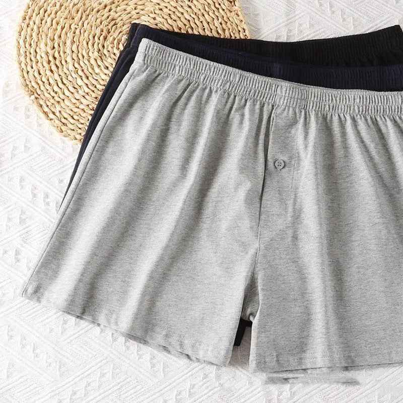 Men's high-waist cotton boxer shorts in black, grey, and navy blue on a size chart