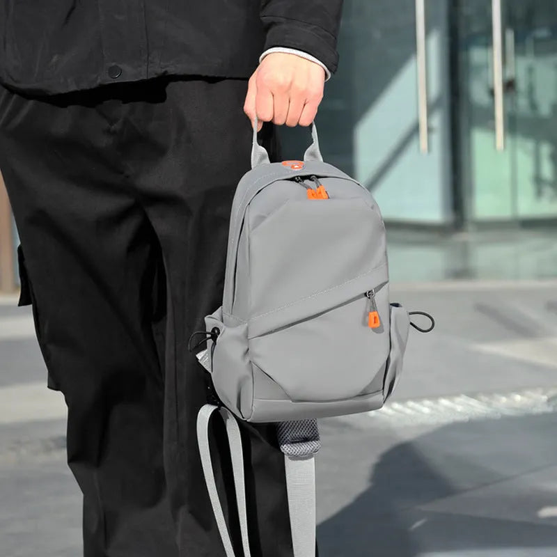 Black and grey mens casual single shoulder crossbody bag made of waterproof polyester.