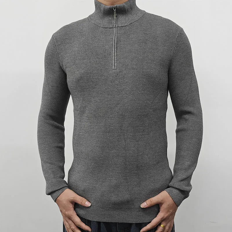 A man's grey half-turtleneck zip-up sweater with long sleeves, shown on a hanger.