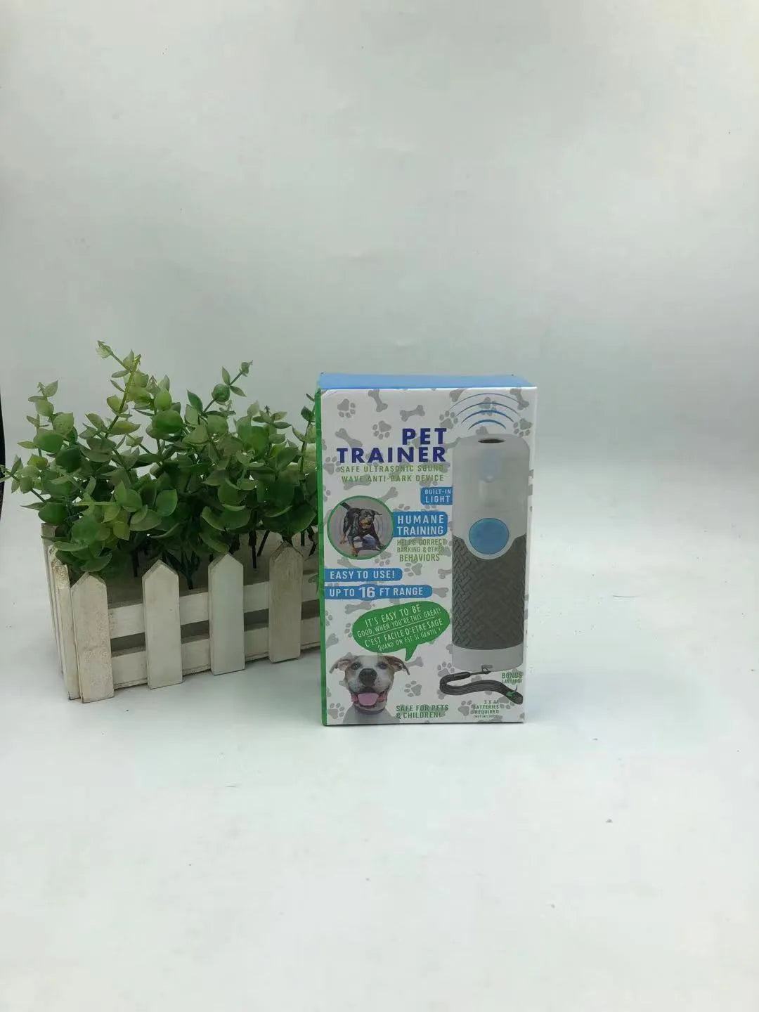 White handheld ultrasonic dog bark control trainer unit on a plain background.