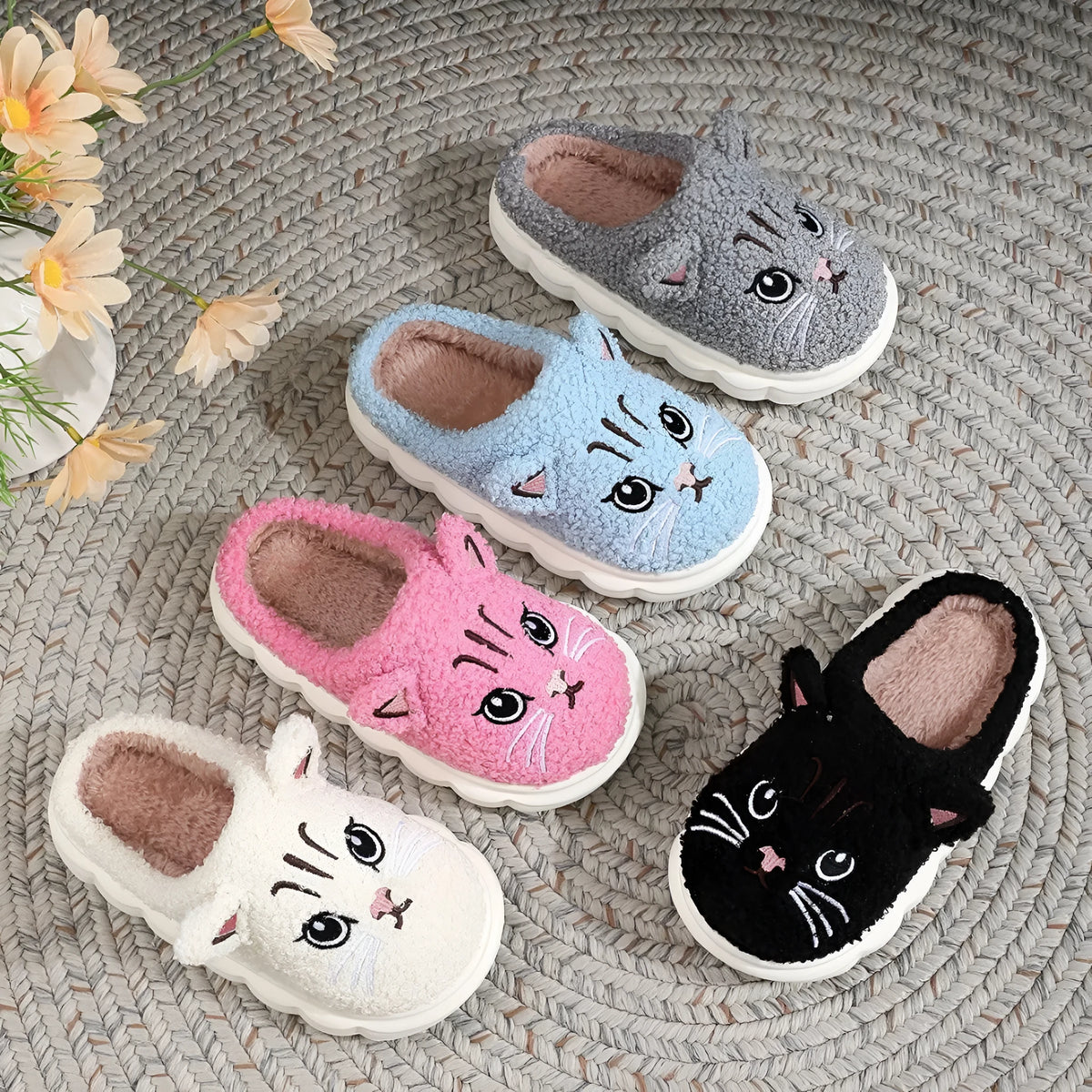 Winter cartoon cat fluffy slippers with plush upper and non-slip EVA sole, in black, white, pink, or grey.