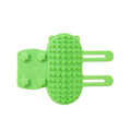 Silicone cat massage comb with rounded teeth and adjustable strap for table leg mounting.