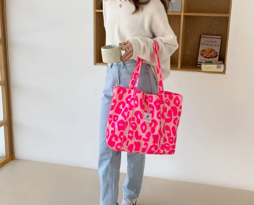 Women's large oxford cloth tote bag with a three-dimensional front pocket in sapphire blue.